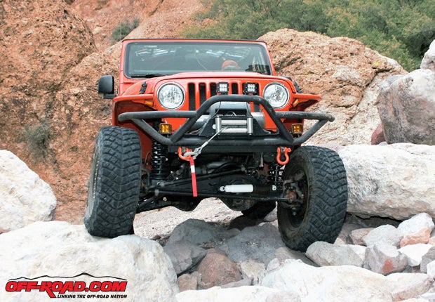 With the Rugged Ridge bumper protecting the grille, TNT Customs side rails, and 35-inch Yokohama Geolandar M/T tires the Jeep can weave among the boulders without a worry.